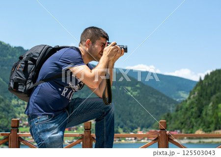 Photographer taking photo of landscape. 125503043