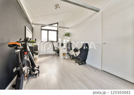 A contemporary home office featuring sleek furniture, natural light, and a clutter-free environment. Perfect for productivity and comfort. 125503081