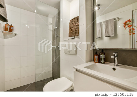 A sleek bathroom showcasing contemporary design elements, including a stylish shower, elegant fixtures, and minimalist decor that enhances the space's functionality. A sleek bathroom showcasing contemporary design elements, including a stylish shower, elegant fixtures, and minimalist decor that enhances the space's functionality. 125503119