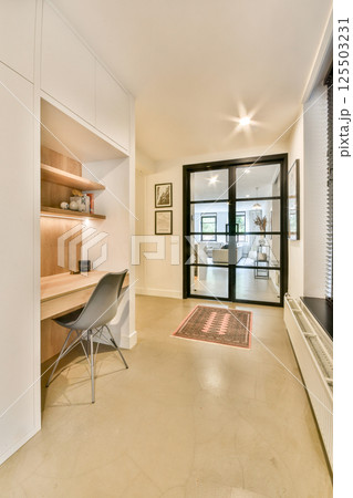 A beautifully designed modern interior featuring a minimalist study space, elegant lighting, and sleek furnishings that exude sophistication and comfort. 125503231