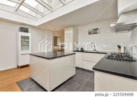 This image showcases a sleek and modern minimalist kitchen featuring clean lines, a bright atmosphere, and functional design elements for a contemporary home. This image showcases a sleek and modern minimalist kitchen featuring clean lines, a bright atmosphere, and functional design elements for a contemporary home. 125504090
