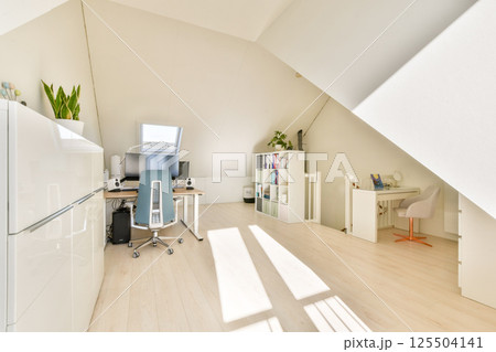 A sleek and modern home office featuring a minimalist design, large windows allowing natural light, greenery, and an organized workstation for productivity. A sleek and modern home office featuring a minimalist design, large windows allowing natural light, greenery, and an organized workstation for productivity. 125504141