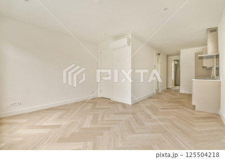 A bright and airy room featuring wooden flooring and clean lines, showcasing a modern minimalist aesthetic perfect for contemporary living. 125504218