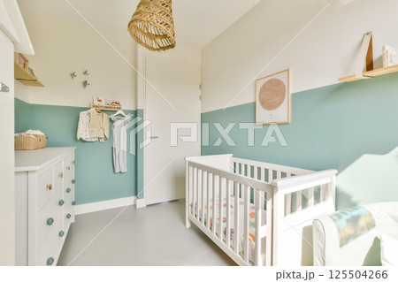 A beautifully designed nursery featuring a crib, stylish decor, and a soft color palette that creates a serene environment for a baby. 125504266