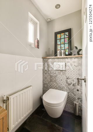 Stylish bathroom showcasing contemporary fixtures, textured walls, and a mix of patterns, creating a serene and functional space. Stylish bathroom showcasing contemporary fixtures, textured walls, and a mix of patterns, creating a serene and functional space. 125504274