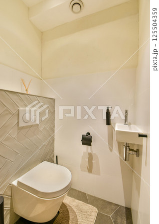 A sleek and contemporary bathroom featuring minimalistic decor, polished surfaces, and efficient fixtures enhancing everyday utility and aesthetics. 125504359