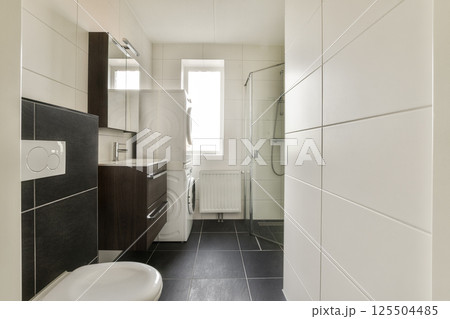 A contemporary bathroom featuring sleek fixtures, neutral colors, and a spacious layout, emphasizing minimalism and functionality. A contemporary bathroom featuring sleek fixtures, neutral colors, and a spacious layout, emphasizing minimalism and functionality. 125504485