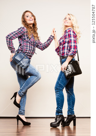 adult daughter and mother with handbags adult daughter and mother with handbags 125504787