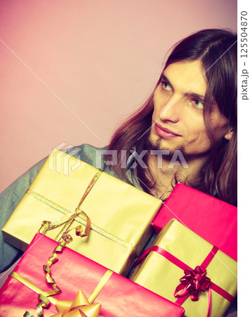 Guy with many presents gift boxes 125504870