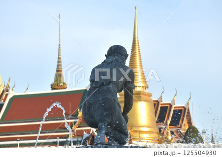 earth goddess on fountain in front of temple of emerald Buddha or wat Phra Kaew travel location and landmark in Thailand in sunset 125504930