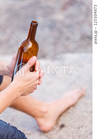 Male hand with wine bottle outdoor Male hand with wine bottle outdoor 125504973