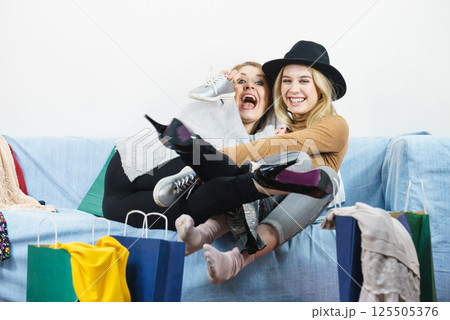 Two happy female friends after shopping 125505376