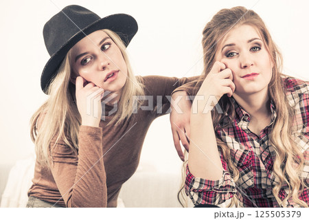 Two women being tired or bored 125505379
