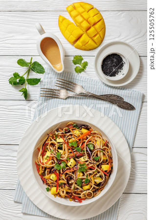 Thai Mango Noodle Veggie Salad in a bowl 125505762