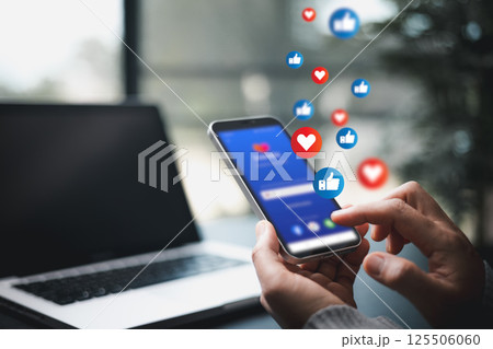 Person used their smartphone to comment, like posts on social media, embracing digital technology that enables live interaction on mobile phones. comment phone, technology digital social media concept 125506060