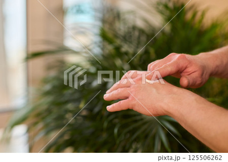 A gloved hand prepares to perform a care procedure safely and professionally in healthcare 125506262