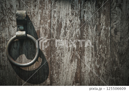 Old barn wooden door with iron ring. Lock door background 125506609