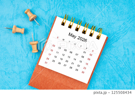 May 2026 mini calendar with wooden thumbtack. 125508434