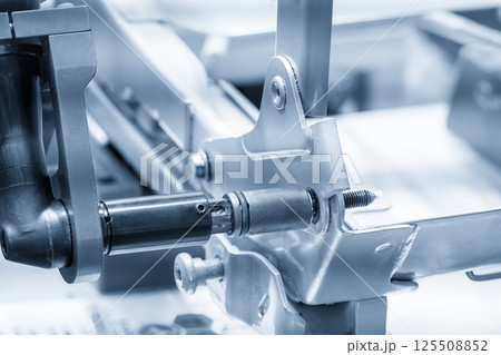 Automotive parts assembly process by the pneumatic wrench in the light blue scene. 125508852