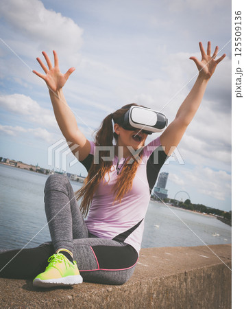 Woman wearing VR outside 125509136