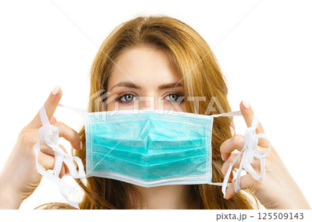 Female using protective face mask. 125509143