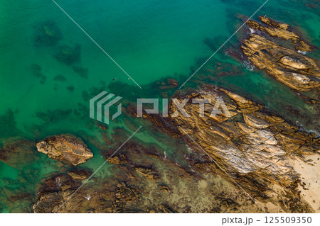 Top view seashore waves nature background,Amazing waves crashing on rocks seascape view Top view seashore waves nature background,Amazing waves crashing on rocks seascape view 125509350