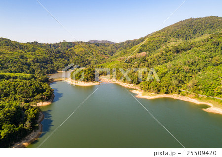 Top down from Drone aerial view of rainforest with asphalt road around the dam Top down from Drone aerial view of rainforest with asphalt road around the dam 125509420