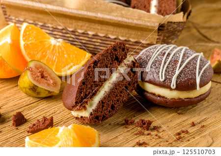 Whoopie pie with orange cream. Delicious homemade dessert Whoopie pie with orange cream. Delicious homemade dessert 125510703