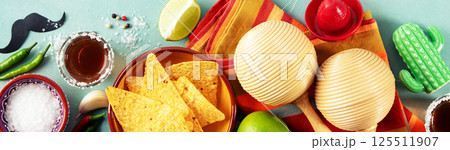 Cinco de Mayo Festive Setup with Nachos, Tequila, and Maracas Cinco de Mayo Festive Setup with Nachos, Tequila, and Maracas 125511907