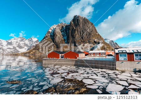 Red Cabins by Frozen Lake and Mountain at Hamnoy village, Lofoten. 125512313