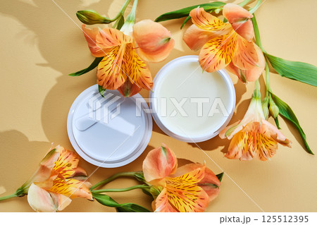 Cleansing hydrophilic balm or butter on a beige background with flowers. Cleansing hydrophilic balm or butter on a beige background with flowers. 125512395
