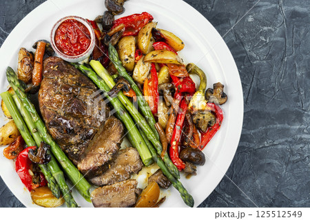 Roasted duck breast with vegetables. 125512549
