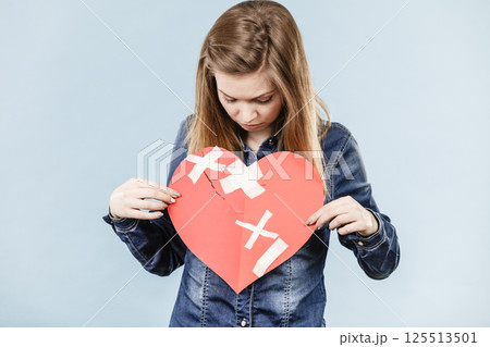 Young woman with broken heart Young woman with broken heart 125513501