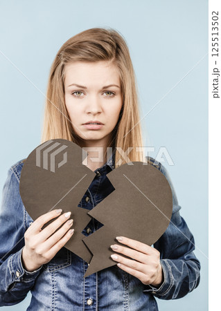 Young woman with broken heart Young woman with broken heart 125513502