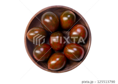 Cherry tomatoes "Chocolate sprinkles" in a plate on white background. 125513790