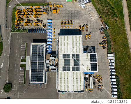 Solar powered construction machinery distribution and service center. Aerial view Solar powered construction machinery distribution and service center. Aerial view 125513821