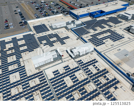 Shopping mall with solar panels on a roof. Aerial view Shopping mall with solar panels on a roof. Aerial view 125513825