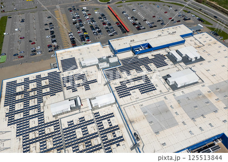 Shopping mall with solar panels on a roof. Aerial view Shopping mall with solar panels on a roof. Aerial view 125513844