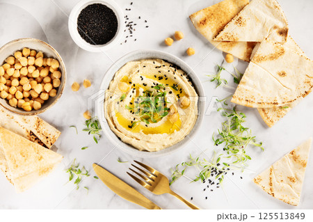 Creamy Hummus with Pita Bread and Black Sesame Seeds Creamy Hummus with Pita Bread and Black Sesame Seeds 125513849