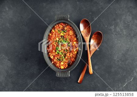 Mexican Chili Con Carne with Wooden Spoons on Dark Background 125513858