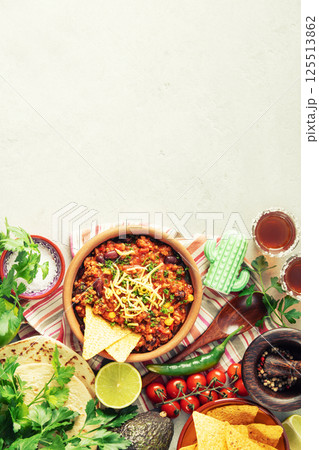 Mexican Beef Chili Con Carne with Nachos and Fresh Ingredients 125513862