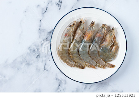 Fresh raw white-footed shrimp, tiger prawns vannamei, on a white plate, Fresh raw white-footed shrimp, tiger prawns vannamei, on a white plate, 125513923