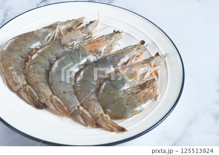 Fresh raw white-footed shrimp, tiger prawns vannamei, on a white plate, Fresh raw white-footed shrimp, tiger prawns vannamei, on a white plate, 125513924