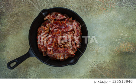 Crispy bacon, in a cast-iron skillet, rustic style, no people Crispy bacon, in a cast-iron skillet, rustic style, no people 125513946