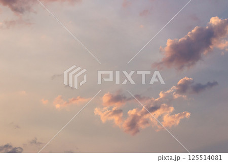 cumulus clouds on the sky blown by the wind. meditation at dusk. cloudy weather meteorology background in orange glow. evening mood 125514081