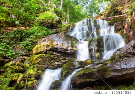 waterfall shypit of carpathian mountains in summer. refreshing relax in woodland. scenery in morning light. popular travel destination of ukraine. cascades over large mossy rocks in the forest 125514086
