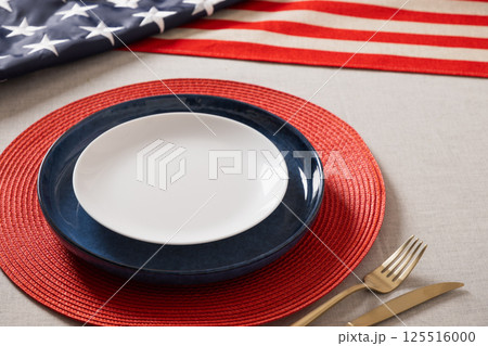 Table setting for USA Independence Day. Festive dinner with empty plate and decoration in USA national flag colors. Happy Memorial Day. Close up. Table setting for USA Independence Day. Festive dinner with empty plate and decoration in USA national flag colors. Happy Memorial Day. Close up. 125516000