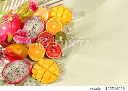 Summer exotic tropical fruits, fruit background. Dragon fruit, pitahaya, mango, blood orange, lemons, kiwi, oranges and fresh juices, banner for cafe or shop, postcard for advertising Asian market Summer exotic tropical fruits, fruit background. Dragon fruit, pitahaya, mango, blood orange, lemons, kiwi, oranges and fresh juices, banner for cafe or shop, postcard for advertising Asian market 125516056