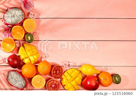 Summer banner with tropical exotic fruits with space for text. Dragon fruit, pitaya, mango, kiwi, avocado, apples, citrus and oranges on sunny table. Healthy vegan food for weight loss Summer banner with tropical exotic fruits with space for text. Dragon fruit, pitaya, mango, kiwi, avocado, apples, citrus and oranges on sunny table. Healthy vegan food for weight loss 125516060