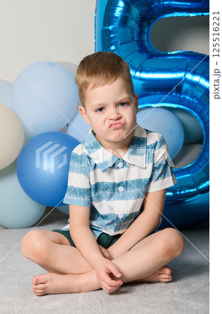 Happy Five Year Old Boy with Number Five Balloon Happy Five Year Old Boy with Number Five Balloon 125516221